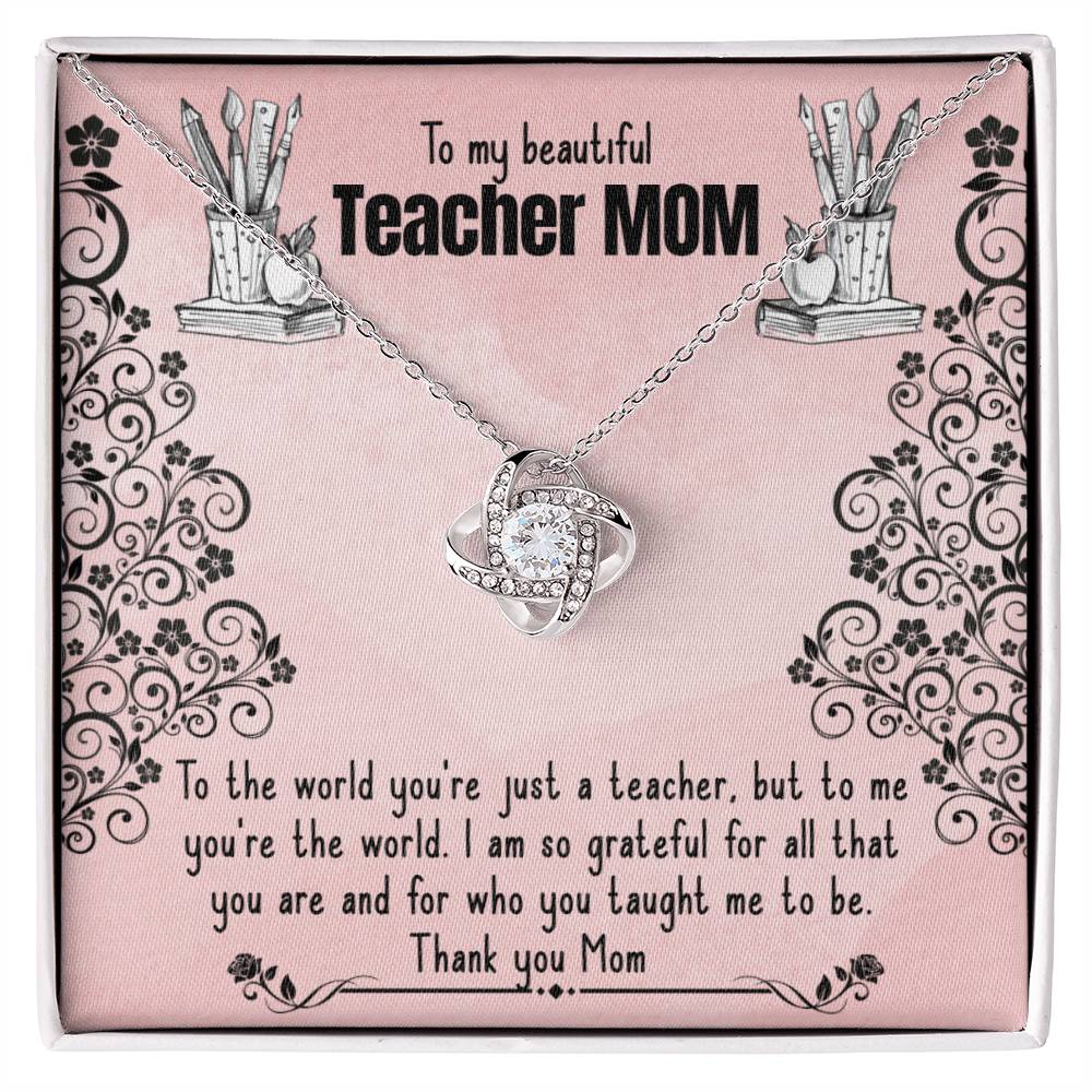 A To My Beautiful Teacher MOM, To The World You're Just A Teacher - Love Knot Necklace with a heart-shaped pendant is displayed on a pink background, featuring a personalized printed message dedicated to a 'teacher mom', expressing gratitude and admiration for her dual role as a mother and.