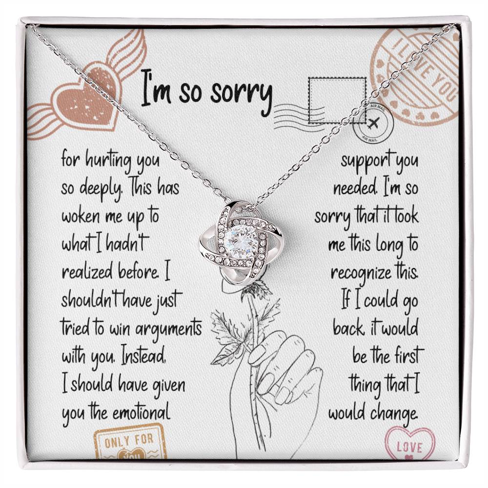 The Sorry-Emotional Support - Love Knot Necklace, featuring an intertwined knot pendant adorned with cubic zirconia crystals, is displayed on a card with an apology message expressing regrets and promising better emotional support in the future.