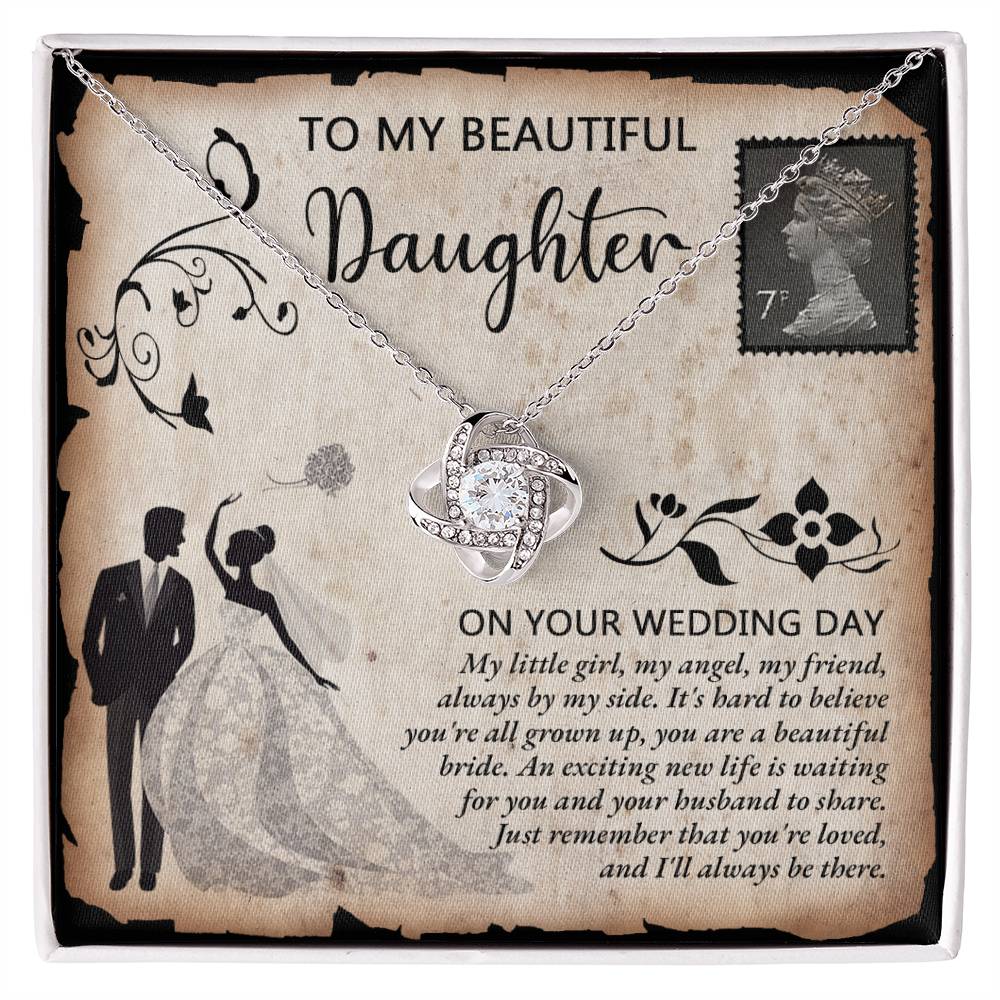 A silver To Daughter Wedding, Beautiful Bride - Love Knot Necklace adorned with cubic zirconia crystals on a card featuring an illustrated bride and groom. The card reads "To my beautiful daughter on your wedding day" with a heartfelt message.