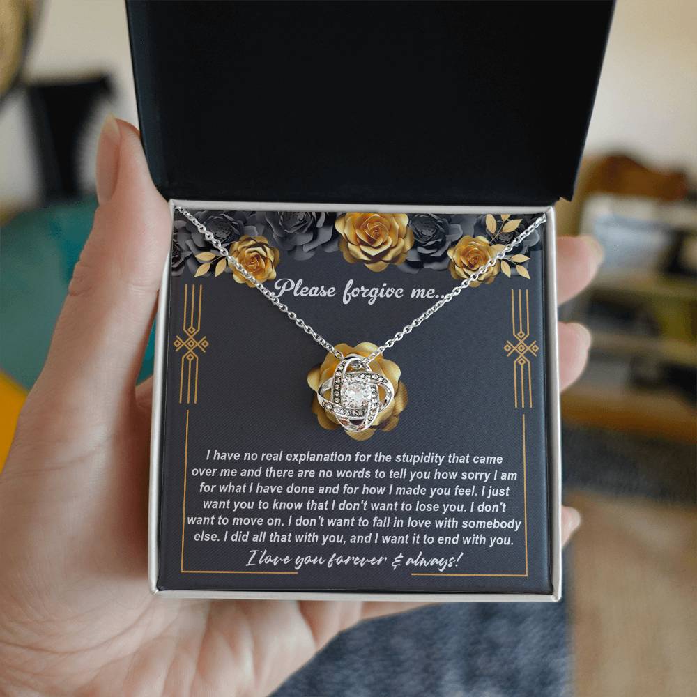 The "Sorry-End With You - Love Knot Necklace" features a beautiful heart-shaped pendant adorned with cubic zirconia crystals, making it a perfect apology gift. The necklace, with its elegant yellow gold finish, is accompanied by a background message expressing deep remorse and a heartfelt desire to stay together.