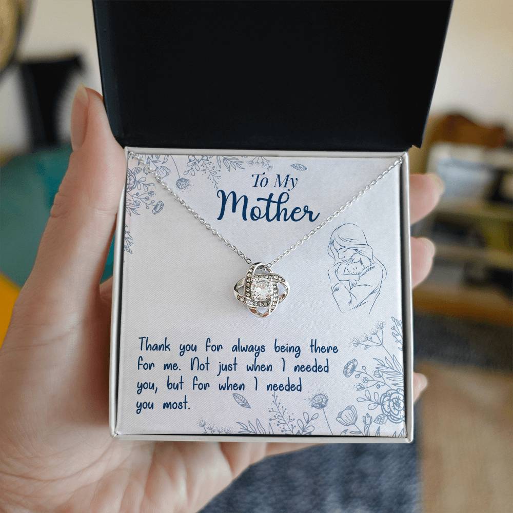 A hand holding a gift box with a To My Mother, Thank You For Always Being There - Love Knot Necklace from ShineOn Fulfillment and a heartfelt message for a mother.