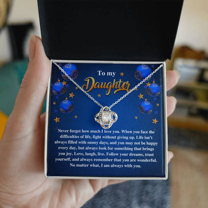 A hand holds an open jewelry box, unveiling the exquisite Daughter-Sunny Days Love Knot Necklace, embellished with cubic zirconia crystals. The box presents a touching message to a daughter about love and encouragement, making it an ideal personalized gift.