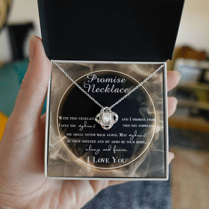 A To Wife, Promise Necklace - Love Knot Necklace with interlocking hearts, adorned with small cubic zirconia crystals and a gold finish, displayed in a box with a romantic message.