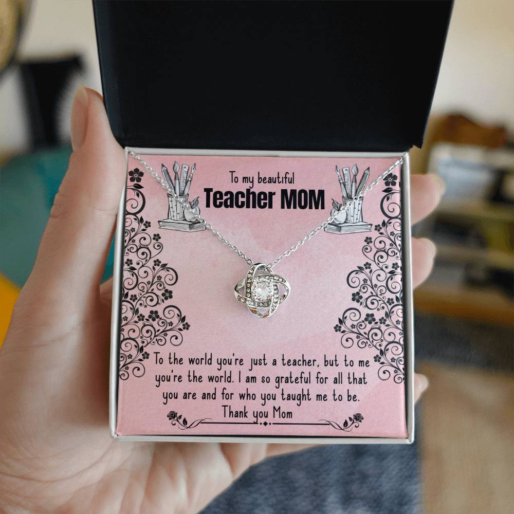 A To My Beautiful Teacher MOM, To The World You're Just A Teacher - Love Knot Necklace is presented inside a box with an affectionate message dedicated to a mother who is also a teacher, expressing gratitude and love by ShineOn Fulfillment.
