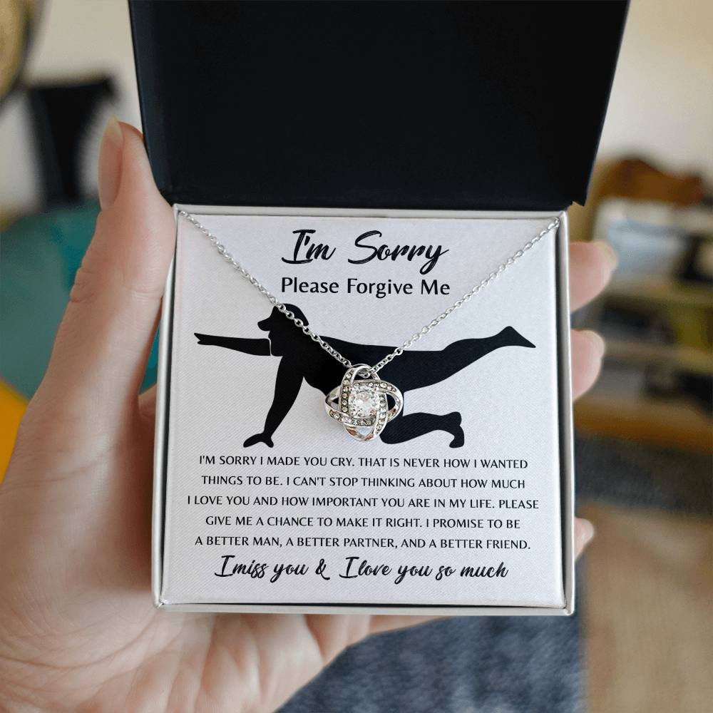 The Sorry-Things to Be Love Knot Necklace features an intertwined knot pendant adorned with cubic zirconia crystals and comes with a heartfelt card that depicts a silhouette of a person kneeling and the words, "I'm sorry, please forgive me... I promise to be a better man..." among other touching text. This classic gift speaks volumes.