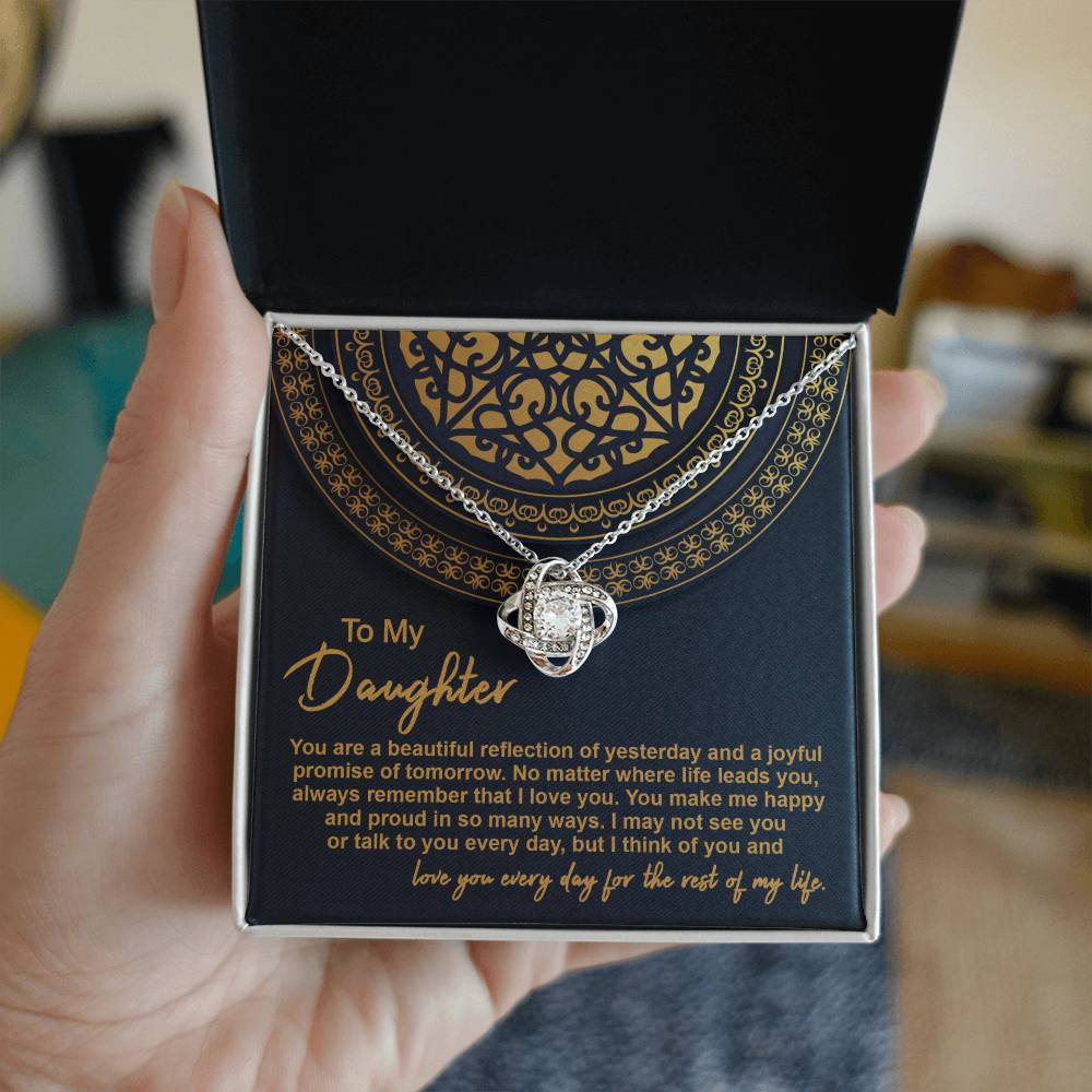 The "To Daughter, Beautiful Reflection 2 - Love Knot Necklace" in 14k white gold is elegantly presented in a black gift box adorned with gold patterns. The box carries the inscription "To My Daughter" along with a heartfelt message expressing love and pride.