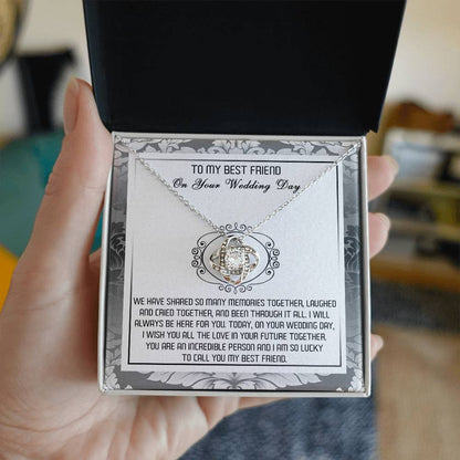 A decorative box containing the "To Best Friend, An Incredible Person - Love Knot Necklace," crafted in 14k white gold with an intricate pendant adorned with cubic zirconia crystals and a heartfelt message titled "To My Best Friend On Your Wedding Day.