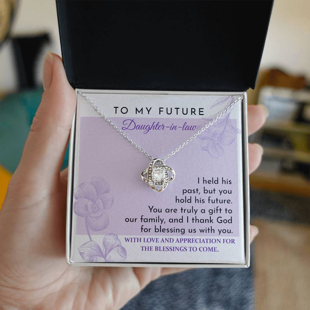 To Daughter-in-law, A Gift - Love Knot Necklace with an intertwined pendant, set against a card reading "To My Future Daughter-in-law," and an appreciation message expressing gratitude and blessings for the future. Decorated with shimmering cubic zirconia, this piece is a glowing testament to your welcome into the family.