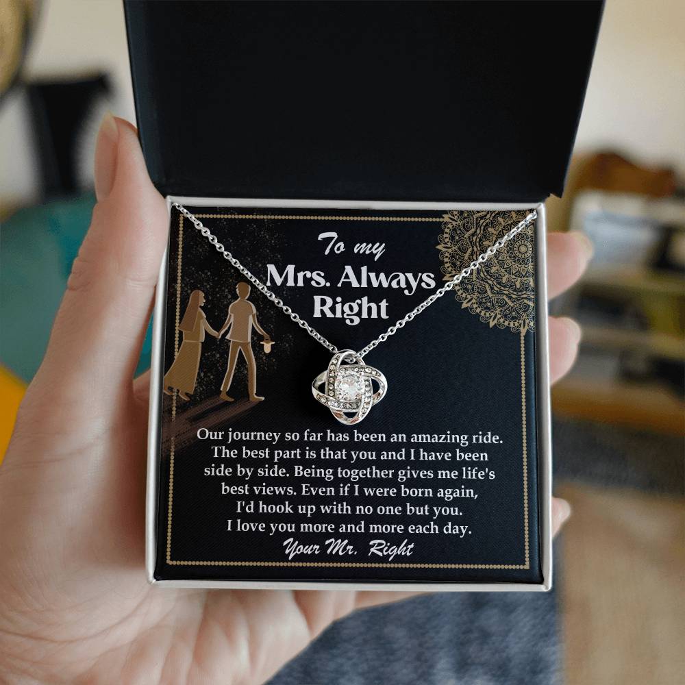 A silver To Wife, Always Right - Love Knot Necklace with an intertwined design, adorned with cubic zirconia crystals, placed on a card that reads: "To my Mrs. Always Right" with a romantic message about love and appreciation.