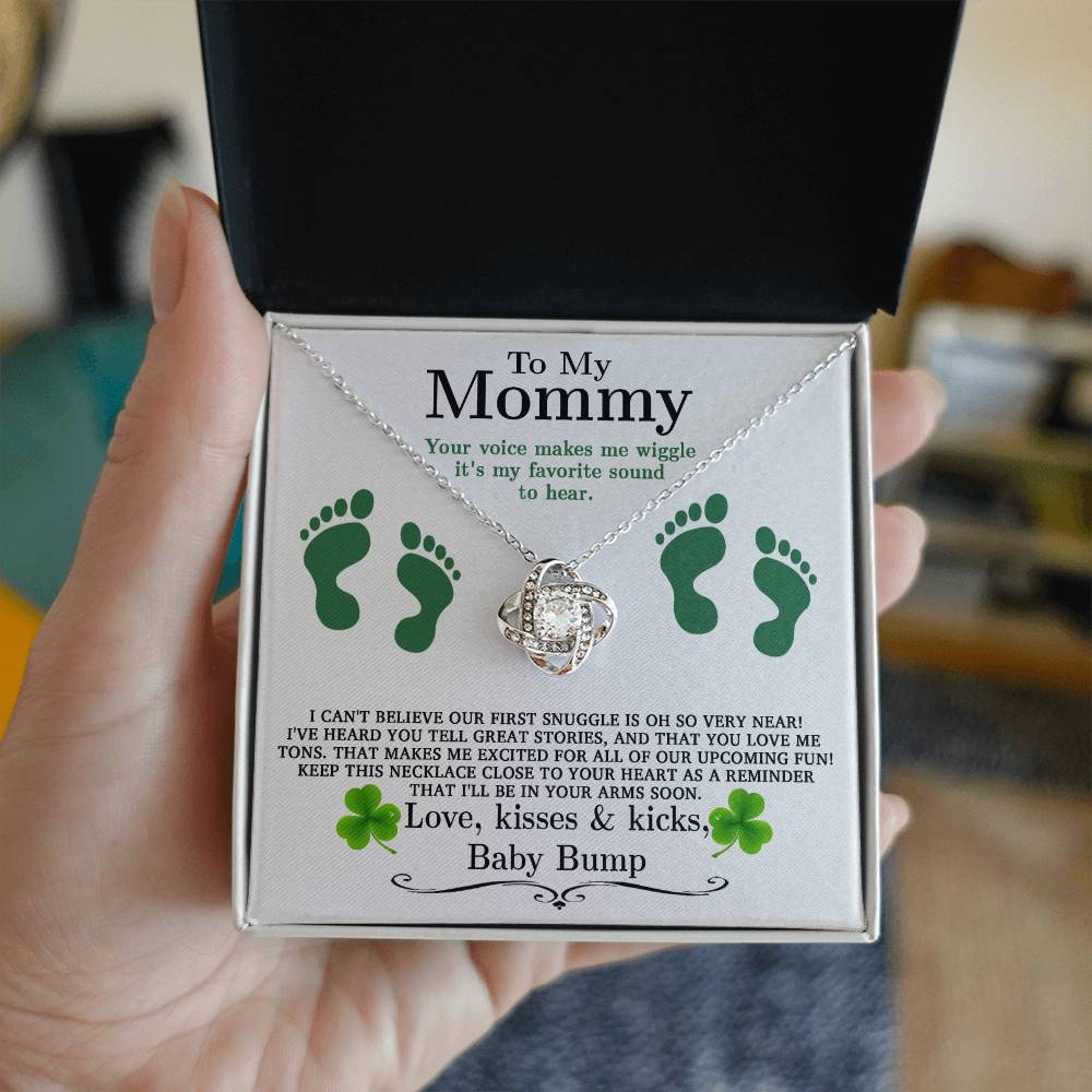 A hand holding a ShineOn Fulfillment To My Mommy, Great Stories - Love Knot Necklace.