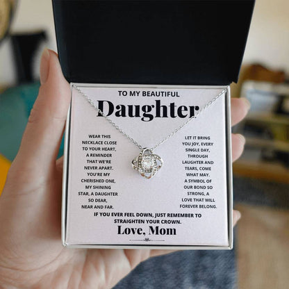To My Beautiful Daughter, Wear This Necklace - Love Knot Necklace shaped pendant necklace with encrusted jewels on a card with a sentimental message from a mother to her daughter.