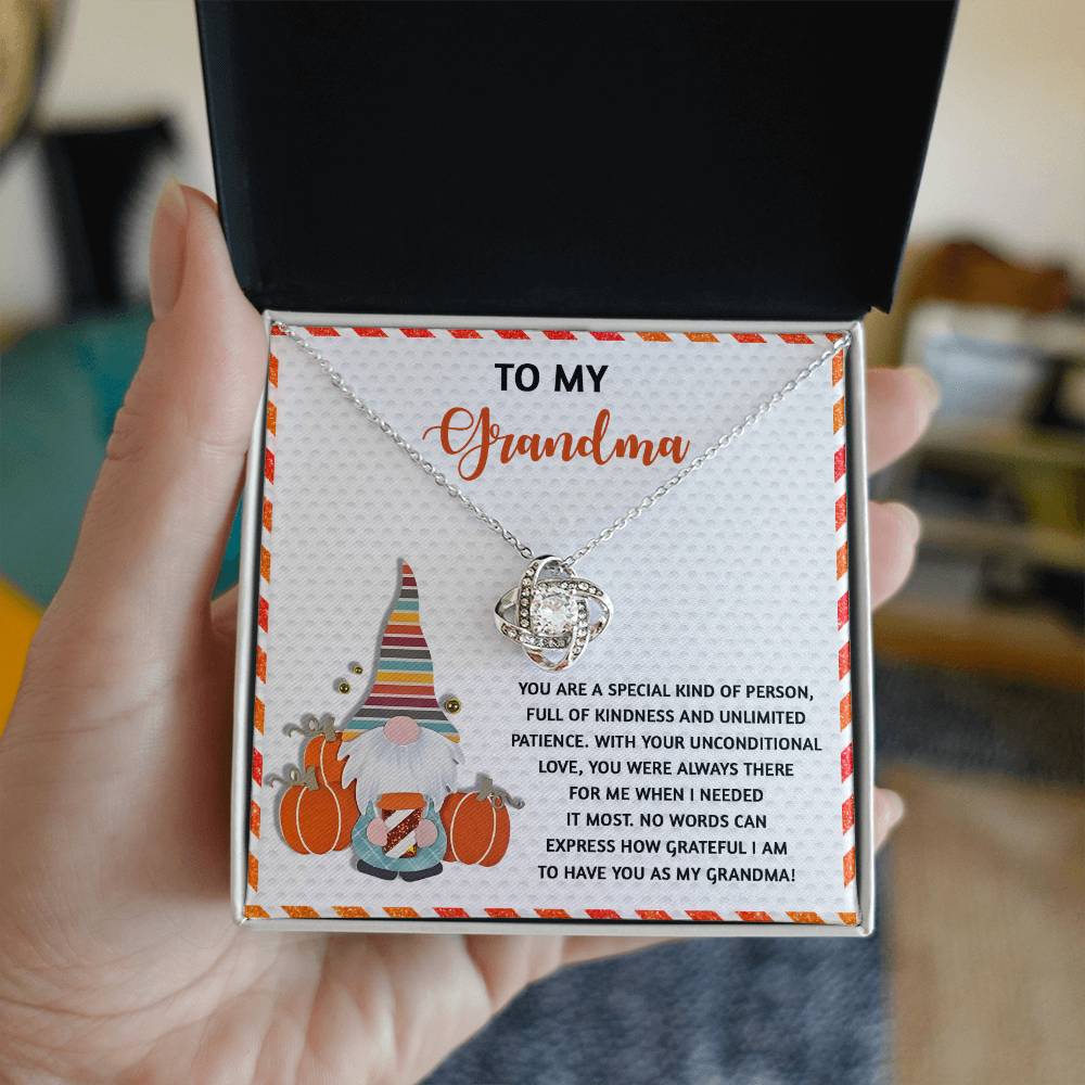 Gift box featuring the "Grandma-Needed It Most - Love Knot Necklace" and a card with the message, "To My Grandma." This personalized gift includes a charming gnome illustration, a heartfelt sentiment, and is embellished with cubic zirconia accents.