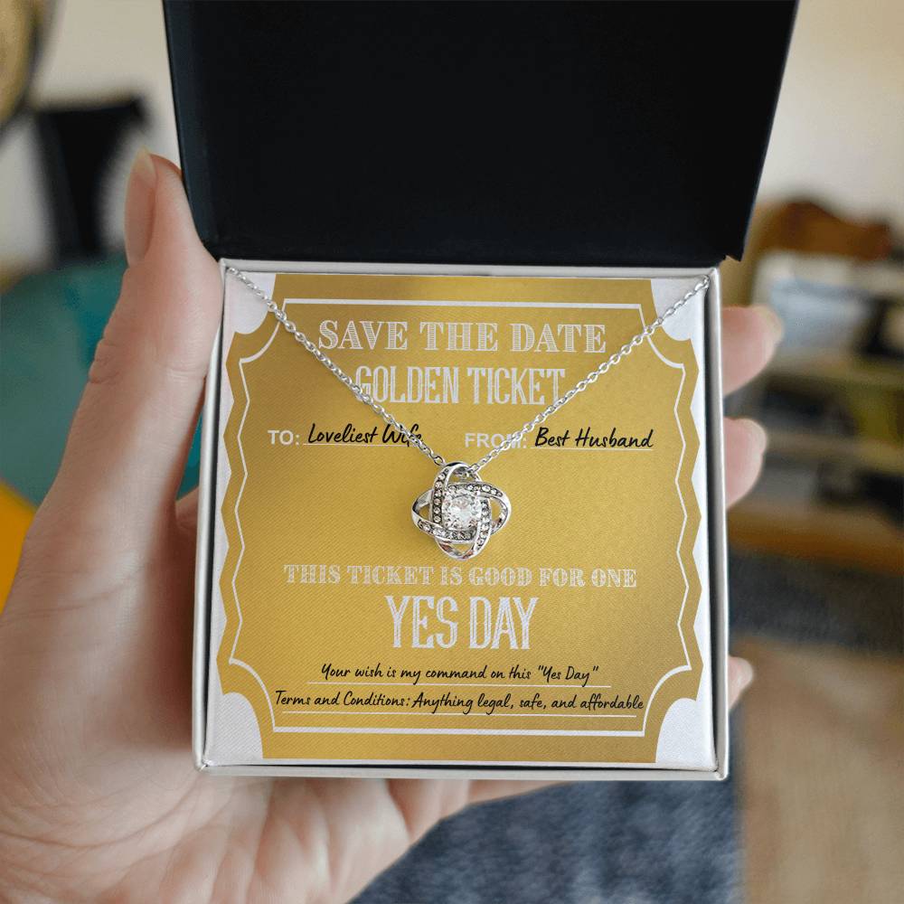 The "To Wife, Golden Ticket - Love Knot Necklace" features interlocked rings on a yellow note that reads "Save the Date Golden Ticket: To: Loveliest Wife, From: Best Husband. Ticket is good for one 'Yes Day.'" Terms and conditions included. This personalized gift sparkles with cubic zirconia crystals, adding a touch of elegance.