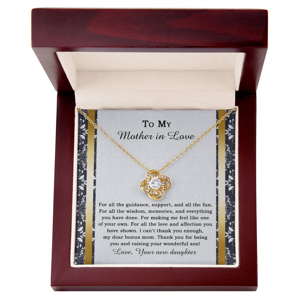 The "To Mother-in-law, Of Your Own - Love Knot Necklace" features a heart-shaped pendant adorned with cubic zirconia crystals, and it comes on a card expressing gratitude for a mother-in-law's love and support.