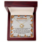 The Daughter-My Greatest Blessing - Love Knot Necklace features a round pendant adorned with cubic zirconia crystals and comes in a wooden box. The interior is decorated with leaves and includes the heartfelt message, "To My Daughter," along with an inspirational note celebrating your unbreakable bond.
