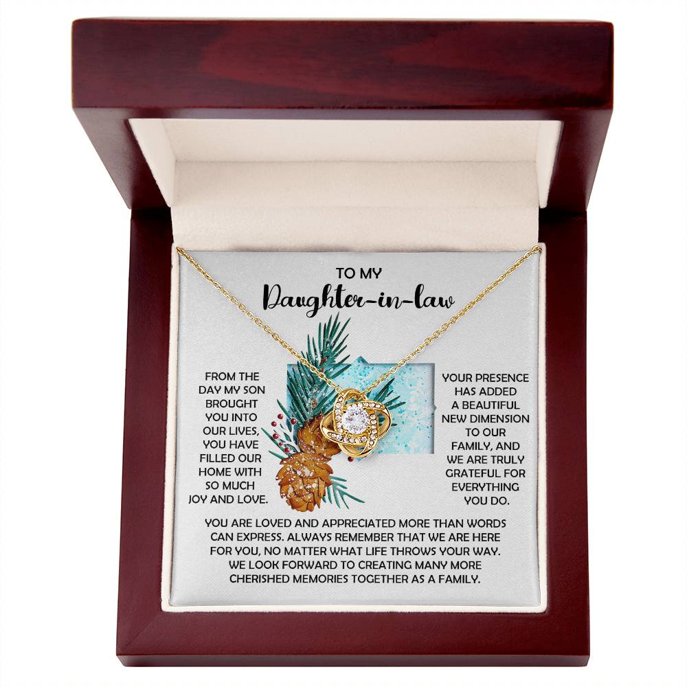 The Daughter-in-Law-Here For You - Love Knot Necklace makes for a unique personalized gift, showcasing dazzling cubic zirconia crystals. It comes beautifully encased in a wooden box and includes a heartfelt message card that conveys love and family connection to your daughter-in-law.