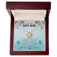 A "My Dear Navy Mom, To The World You're Just A Navy Officer" Love Knot Necklace with cubic zirconia crystals, sits inside a presentation box with a message for expressing love and gratitude. (Brand: ShineOn Fulfillment)