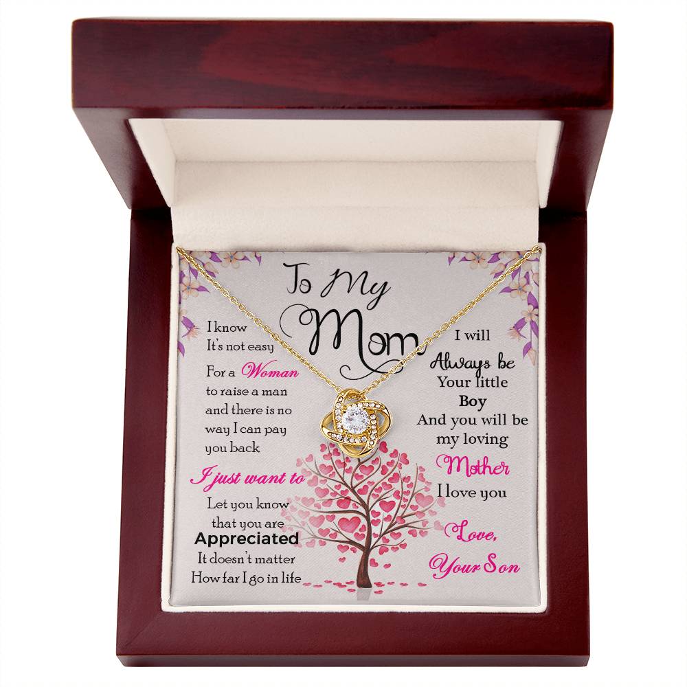 A To My Mom, I Know Its Not Easy Love Knot Necklace with a gold finish in a gift box, carrying a sentimental message for mom from her son by ShineOn Fulfillment.