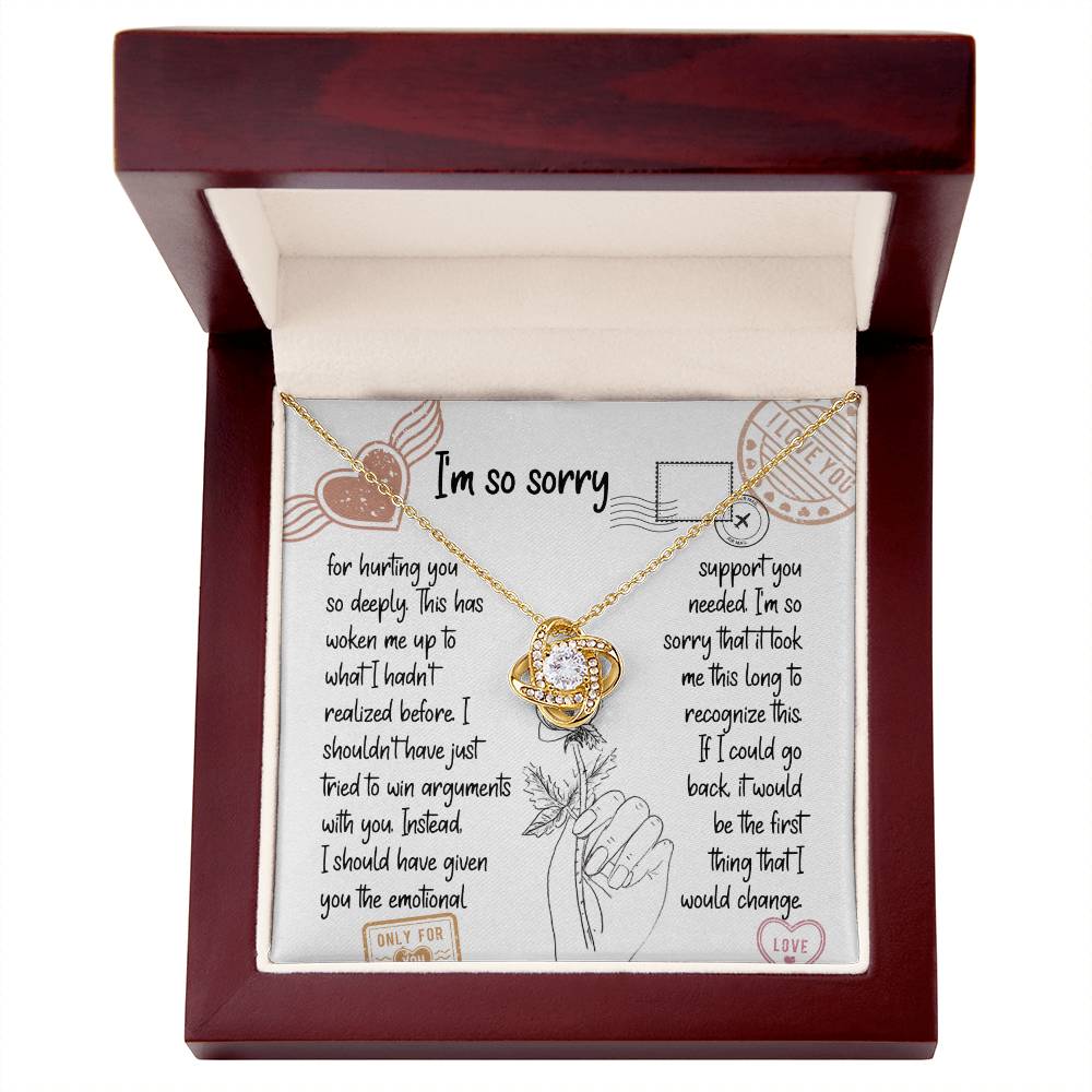 The Sorry-Emotional Support - Love Knot Necklace, featuring an intertwined knot pendant adorned with cubic zirconia crystals, is displayed on a card with an apology message expressing regrets and promising better emotional support in the future.