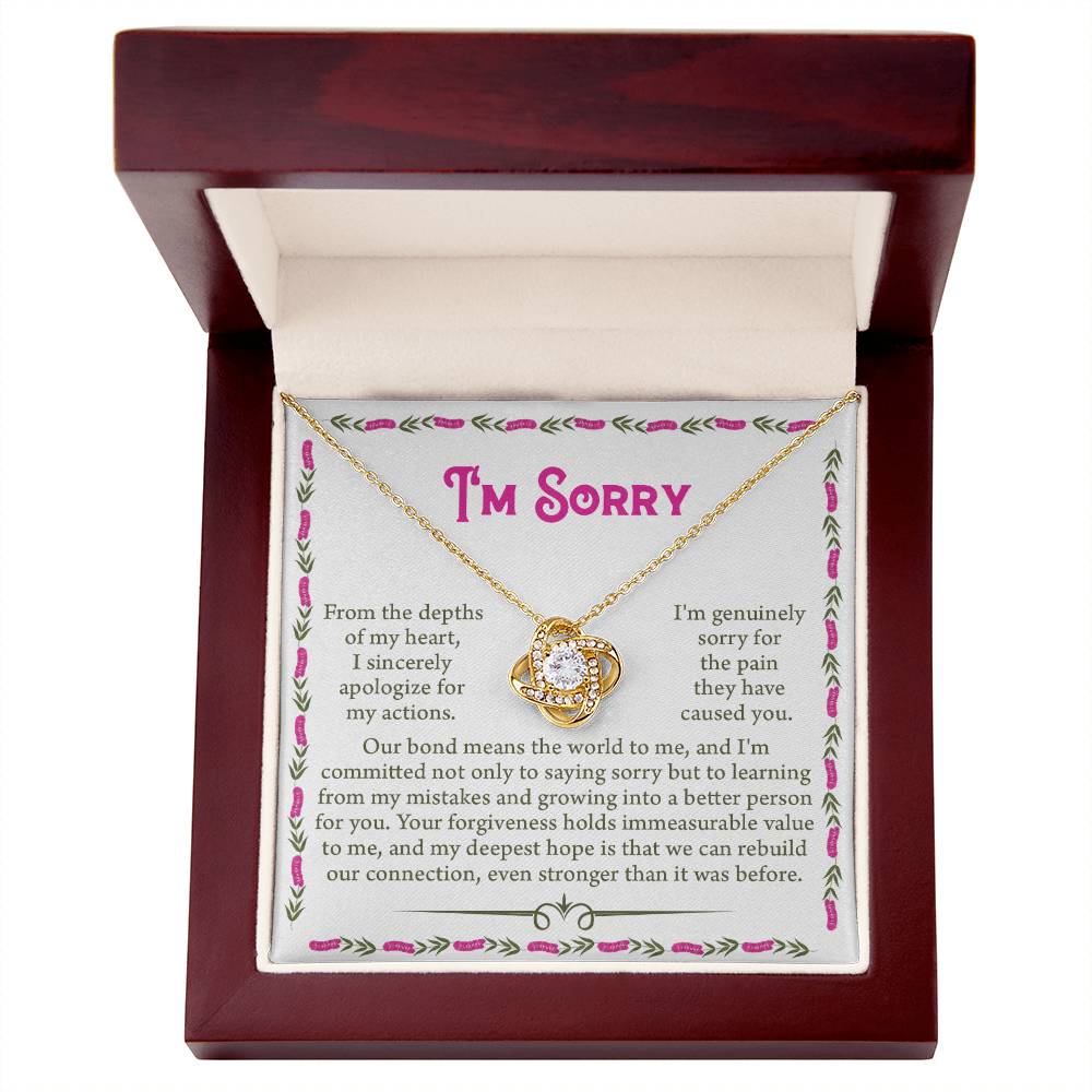 The Sorry-A Better Person - Love Knot Necklace is elegantly presented in an open wooden jewelry box. Inside, the necklace, adorned with dazzling cubic zirconia crystals, nestles perfectly. Accompanying it is an apology card, starting with "I'm sorry," which conveys deep remorse and a sincere plea for forgiveness—making it an ideal gift for loved ones.