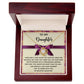 Introducing the Daughter-Spend With You Love Knot Necklace, featuring a beautifully adorned pendant in a wooden box with a heartfelt message for your daughter, expressing pride and love. The pendant is embellished with sparkling cubic zirconia crystals and presented with a purple ribbon. Choose either a white gold or yellow gold finish for an extra touch of elegance.