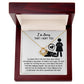 The Sorry-Stop Talking - Love Knot Necklace is displayed in an open wooden box, adorned with Cubic Zirconia Crystals and accompanied by a heartfelt apology message about regret and the desire to make amends.