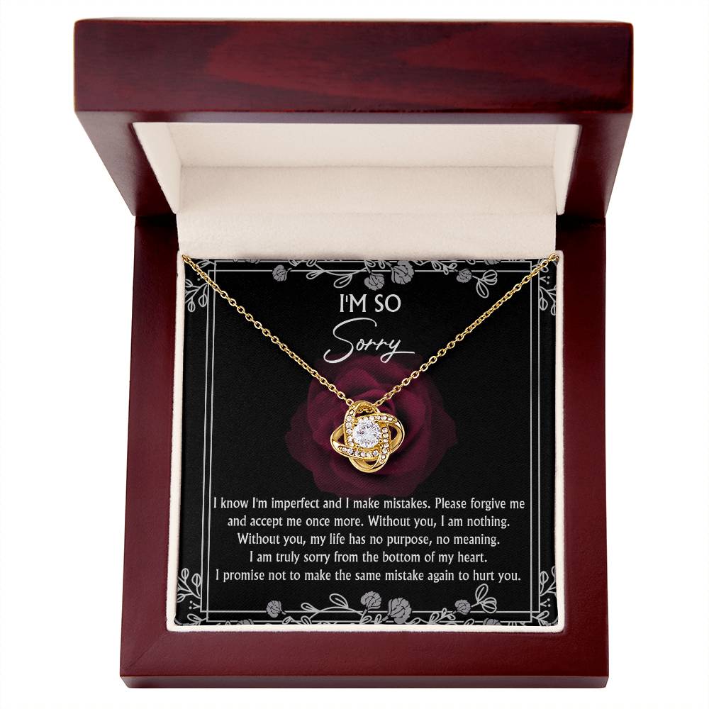 A "Sorry-I Am Nothing - Love Knot Necklace" adorned with cubic zirconia crystals is displayed in an open wooden box. Inside the personalized gift box, there is an apology message with a rose design.