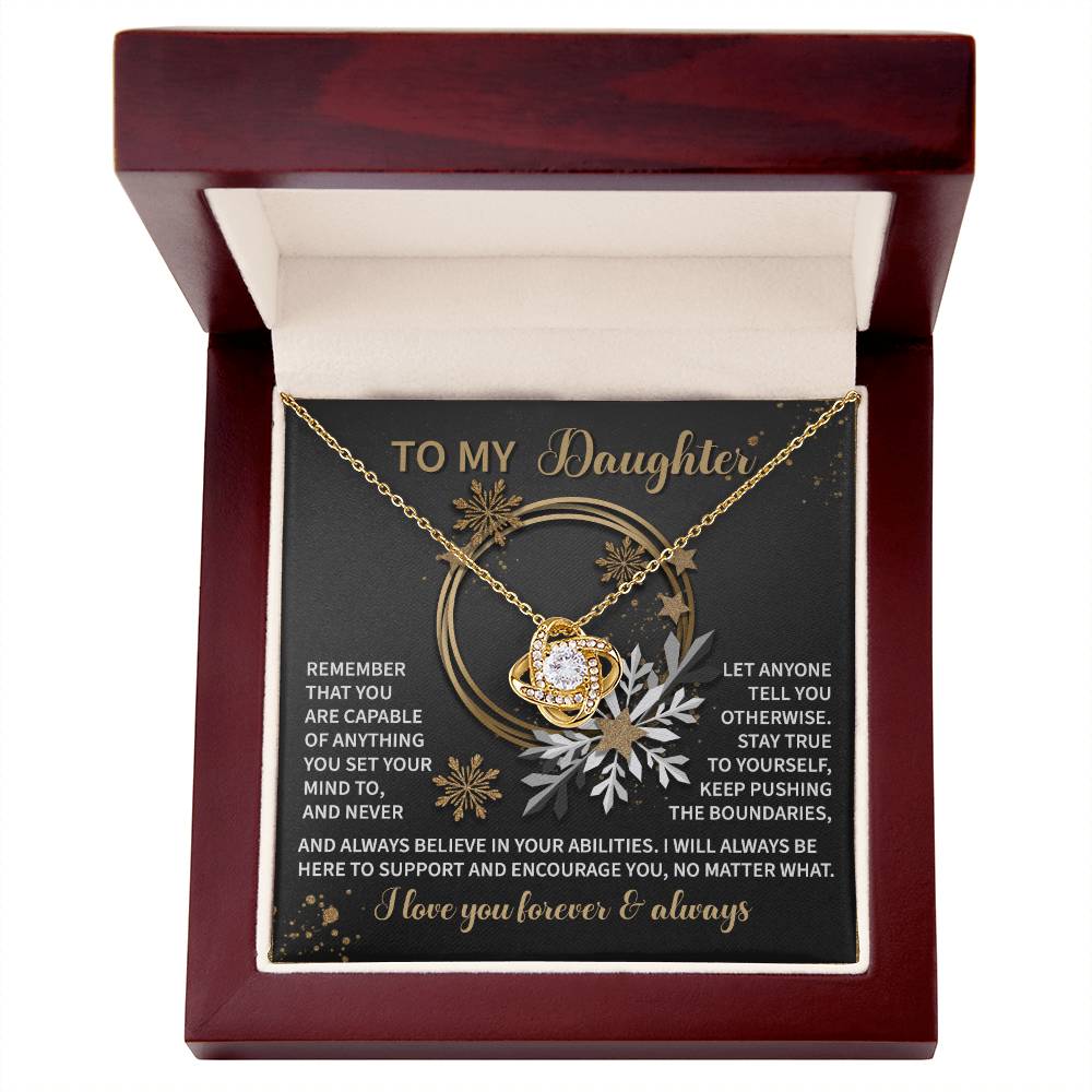 The Daughter-Set Your Mind - Love Knot Necklace comes beautifully nestled in a gift box adorned with floral decorations and an inspiring message for a daughter. Featuring a cubic zirconia pendant that adds elegance, this piece perfectly conveys love and support, making it an ideal personalized gift.