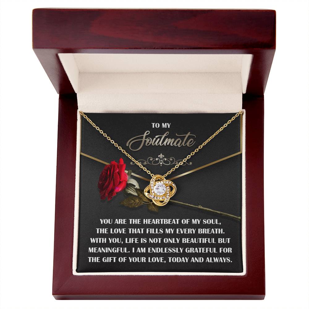 The Soulmate-My Every Breath Love Knot Necklace, featuring cubic zirconia crystals, shines in a red box. The lid bears a rose and the inscription "To My Soulmate," with a touching message celebrating a strong bond of love and gratitude.