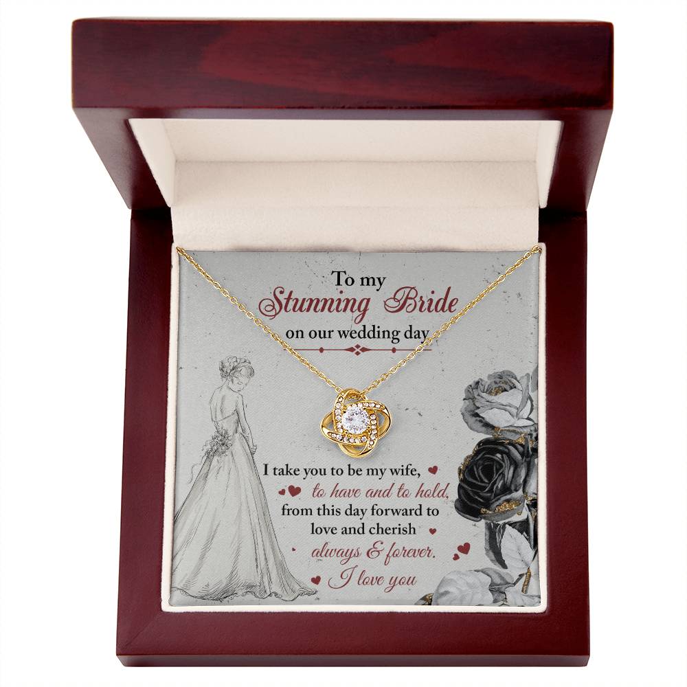 A To My Bride, Be My Wife - Love Knot Necklace with a pendant adorned in cubic zirconia crystals is displayed against a background featuring a bride illustration and a heartfelt wedding message.