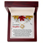 The Daughter-Fill Your Life - Love Knot Necklace, featuring a circular pendant, is elegantly presented inside a dark red jewelry box. The interior showcases a heartfelt message for a daughter, surrounded by autumn leaves and embellished with cubic zirconia crystals, making it the ideal personalized gift.