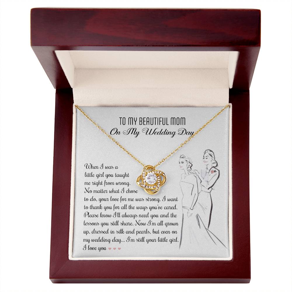 A To Mom, Wedding My Wedding Day - Love Knot Necklace with a card that reads: "To my beautiful mom on my wedding day" with a sentimental message about a daughter's gratitude towards her mother, featuring an illustration of a bride and her mother. The necklace is made of 14k white gold and adorned with cubic zirconia crystals.