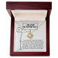 A classic gift, the Sorry-Missing Piece Love Knot Necklace features a large gemstone and is displayed in a wooden box. The box's interior shows a stick figure holding a sign that reads "I am sorry for hurting you," with text below offering an apology. Cubic zirconia crystals enhance this heartfelt gesture with an extra touch of elegance.