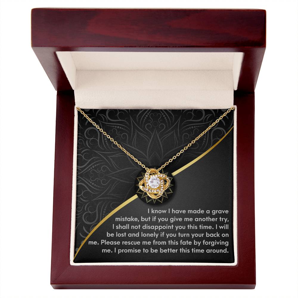 A "Sorry-Turn Your Back" Love Knot Necklace featuring a star-shaped pendant adorned with cubic zirconia crystals, elegantly presented in a red velvet gift box. The lid of the box displays an apology message asking for forgiveness and another chance.