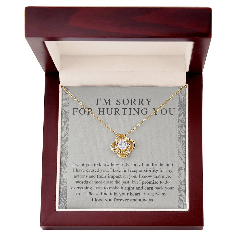 The Sorry-Do Everything - Love Knot Necklace features an eye-catching silver intertwined pendant, elegantly adorned with cubic zirconia crystals, showcased against a heartfelt printed apology message. The message conveys sincere regret, taking responsibility, and earnestly asking for forgiveness with love.