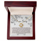 The "Sorry-Your Big Heart - Love Knot Necklace" features a circular pendant adorned with premium cubic zirconia crystals, elegantly presented in an open wooden box. The lid of the box showcases an apology message surrounded by floral illustrations, making it an ideal personalized gift.