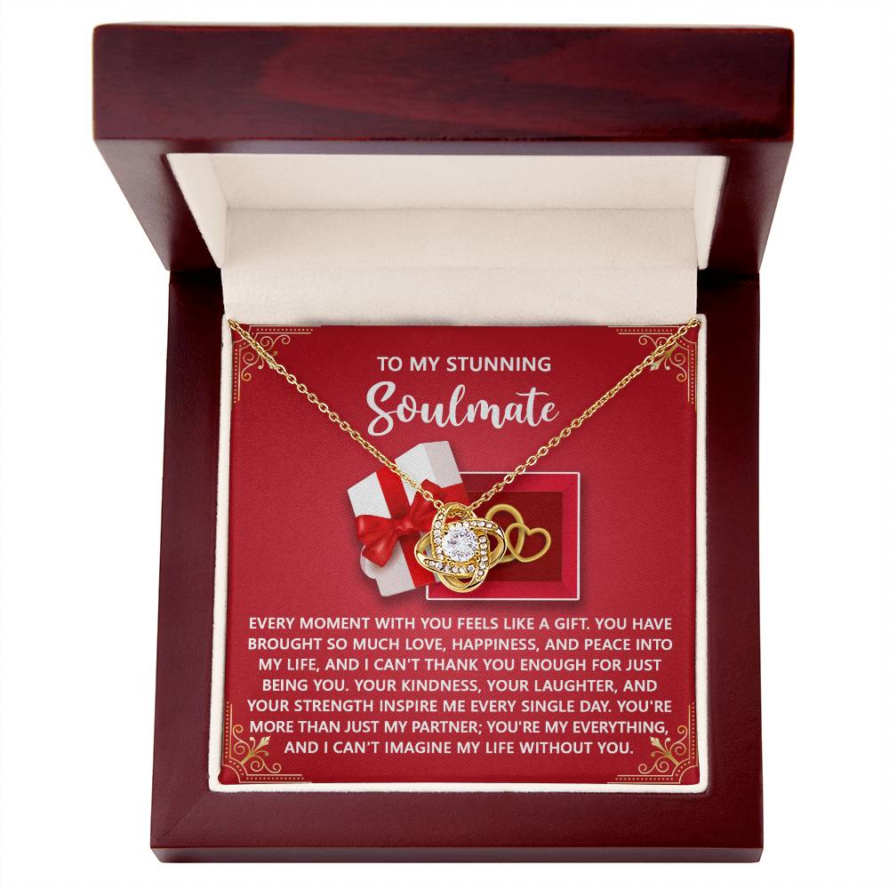 The Soulmate-Like A Gift - Love Knot Necklace features interlocking hearts embellished with cubic zirconia crystals, set in a box. It includes a heartfelt "To My Stunning Soulmate" card and is available in white or yellow gold finish, making it an enchanting gift option.