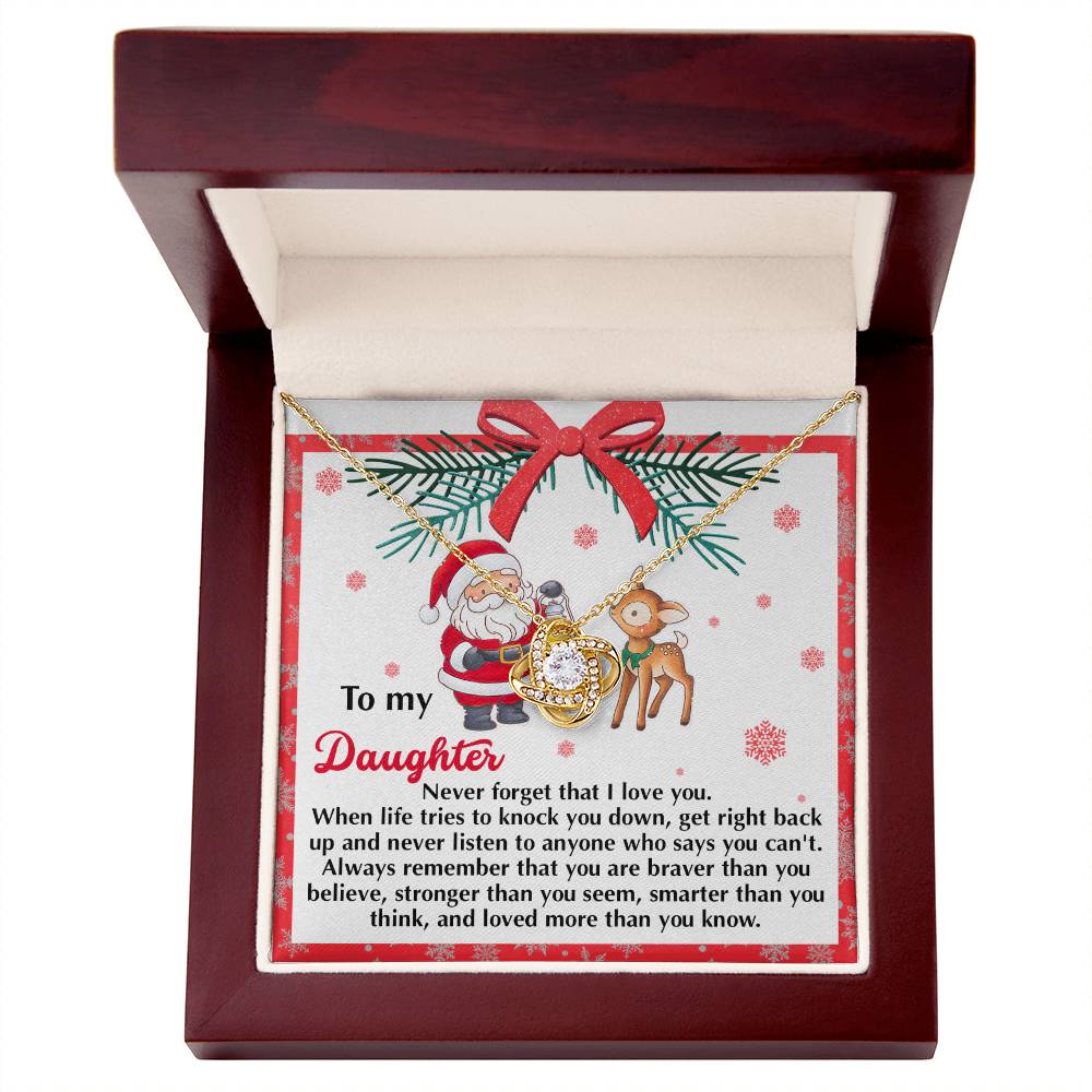 Presenting the Daughter-Get Back Up - Love Knot Necklace in an open wooden jewelry box, sparkling with cubic zirconia. Accompanied by a heartfelt message card that says: "To my Daughter," featuring an inspirational quote alongside a charming Santa and reindeer illustration, this makes for a truly personalized gift suitable for any occasion.