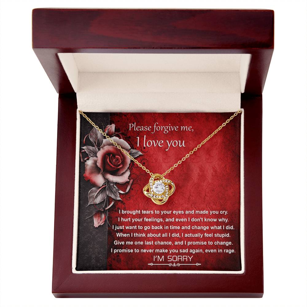 The Sorry-One Last Chance - Love Knot Necklace features a pendant with a central gem, adorned with premium cubic zirconia crystals, and is presented in a wooden box that includes a heartfelt apology message expressing love and seeking forgiveness.