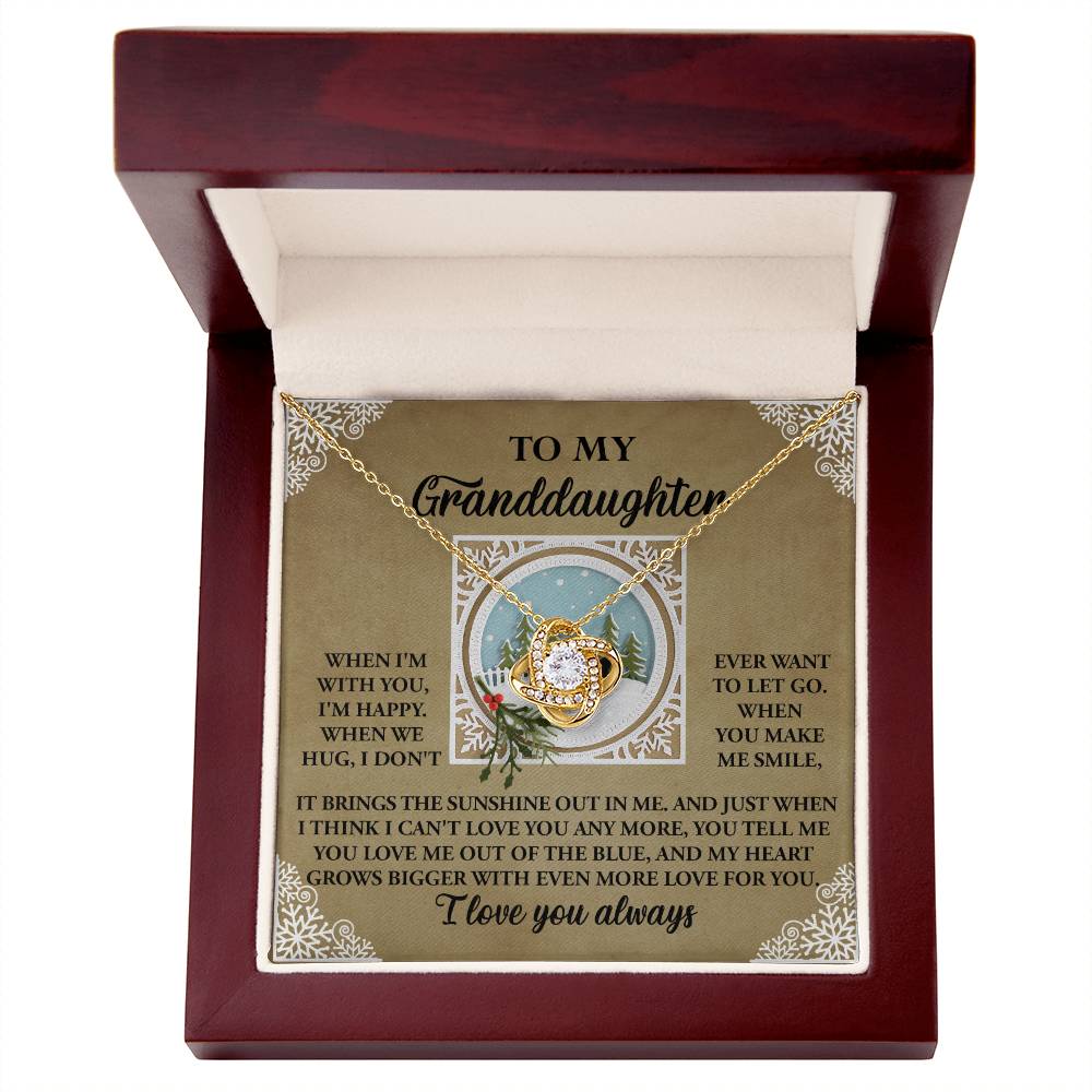 The Granddaughter-Grows Bigger Love Knot Necklace comes beautifully packaged in a wooden box with a heartfelt message for your granddaughter and showcases a circular pendant adorned with cubic zirconia crystals. It is available in both a stunning white gold or yellow gold finish.