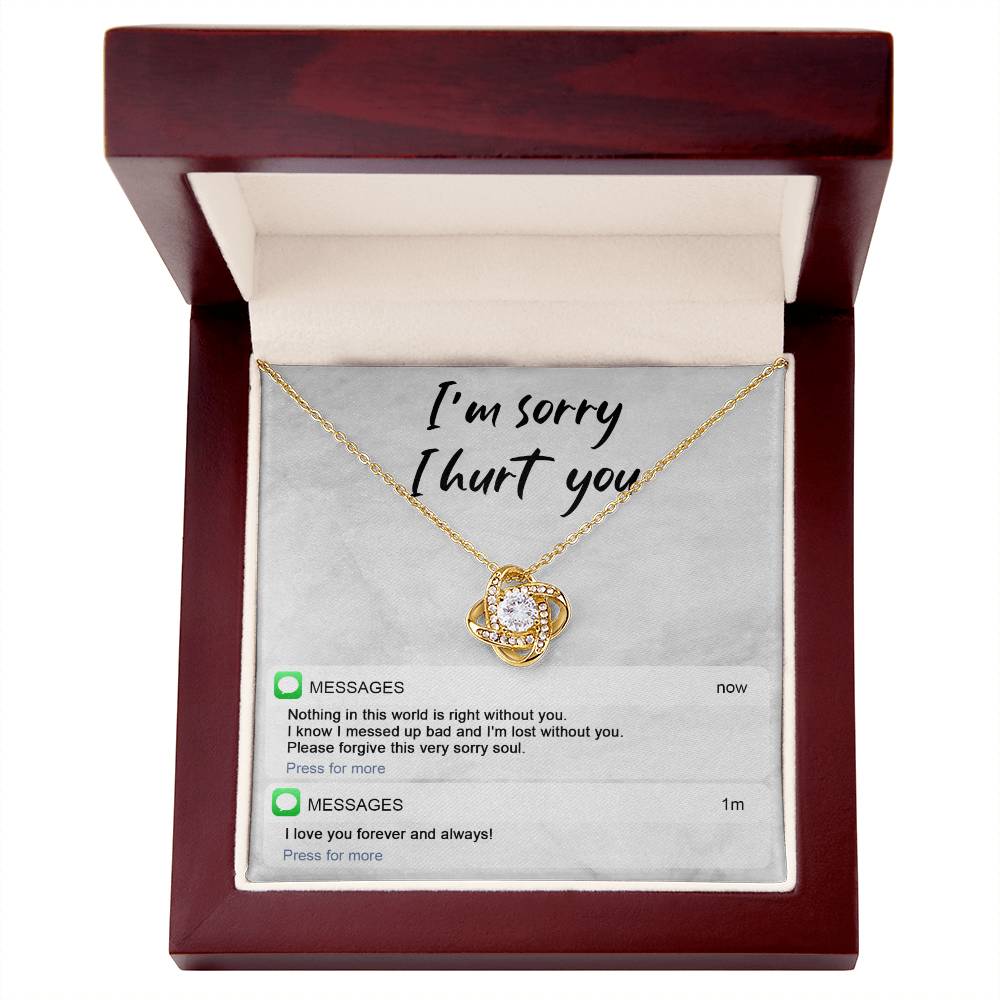 Image of the Sorry-Lost Without You - Love Knot Necklace with a diamond pendant against a background with the text "I'm sorry I hurt you." Below are text messages reading "Nothing in this world is right without you... Please forgive this very sorry soul." and "I love you forever and always!