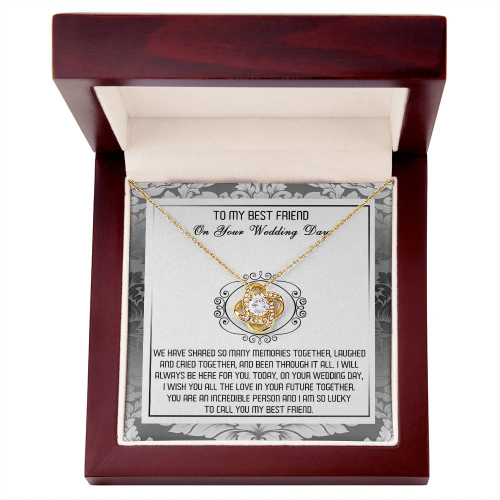 A decorative box containing the "To Best Friend, An Incredible Person - Love Knot Necklace," crafted in 14k white gold with an intricate pendant adorned with cubic zirconia crystals and a heartfelt message titled "To My Best Friend On Your Wedding Day.