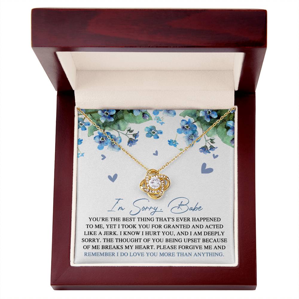 Introducing the "Sorry-More Than Anything - Love Knot Necklace," featuring a cubic zirconia pendant set against a floral background. This heartfelt personalized gift comes with a note that reads, "I'm Sorry, Babe. You're the best thing that's ever happened to me... Please forgive me and remember I do love you more than anything.