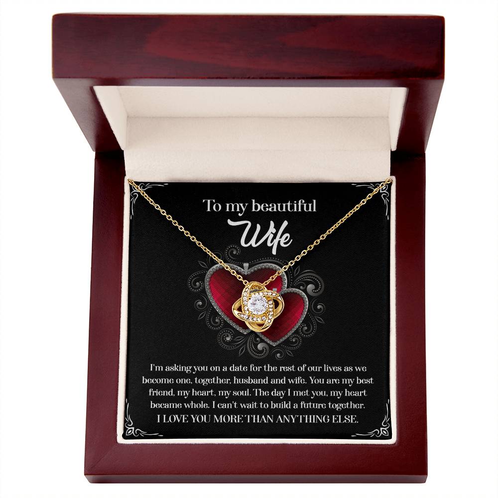 A To Wife, Heart Became Whole - Love Knot Necklace in a gift box, adorned with sparkling cubic zirconia crystals and accompanied by a heartfelt message for a wife, expressing love and a desire to build a future together.