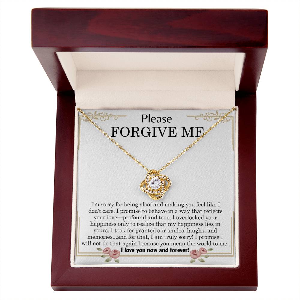 The "Sorry, Profound And True - Love Knot Necklace," featuring an intertwined heart pendant, is elegantly displayed in a box. The message "Please FORGIVE ME!" along with a heartfelt apology note is printed inside the box and beautifully accentuated by cubic zirconia crystals.