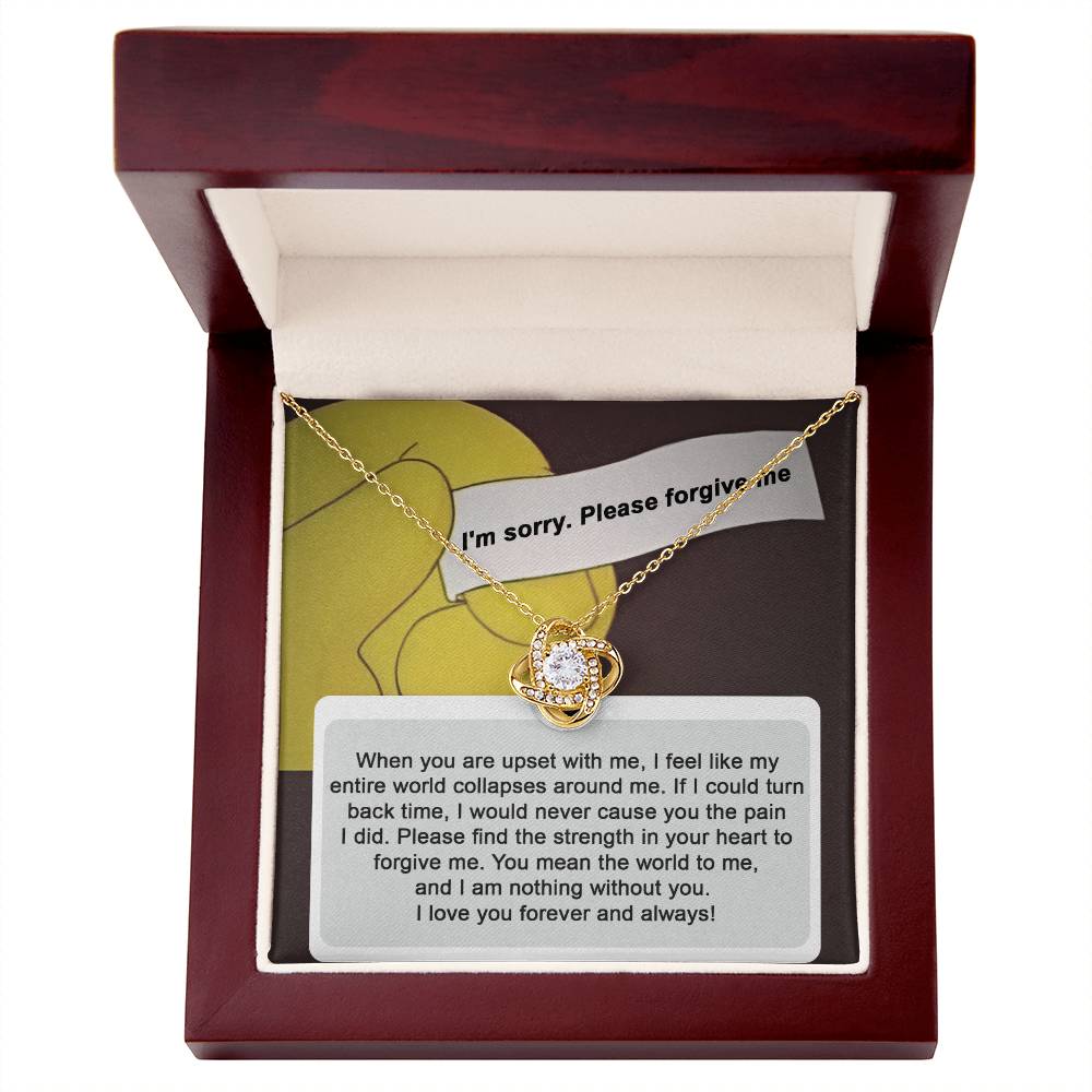 A "Sorry, Nothing Without You" Love Knot Necklace adorned with cubic zirconia crystals is elegantly placed over a card that reads, "When you are upset with me..." and continues with a heartfelt apology and expression of love.