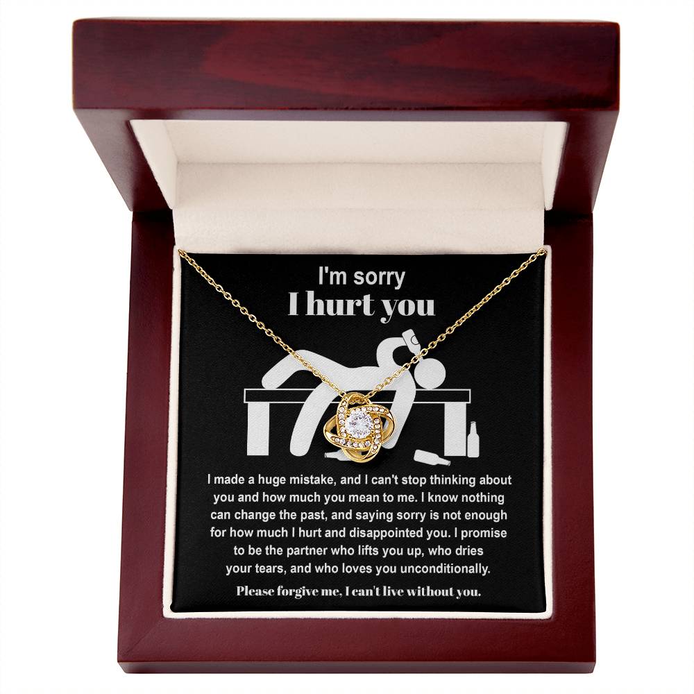 The Sorry-Change The Past 2 - Love Knot Necklace, featuring a heart pendant adorned with cubic zirconia crystals, is presented in a wooden box. Inside the box, you'll find an apology message on a personalized gift card.