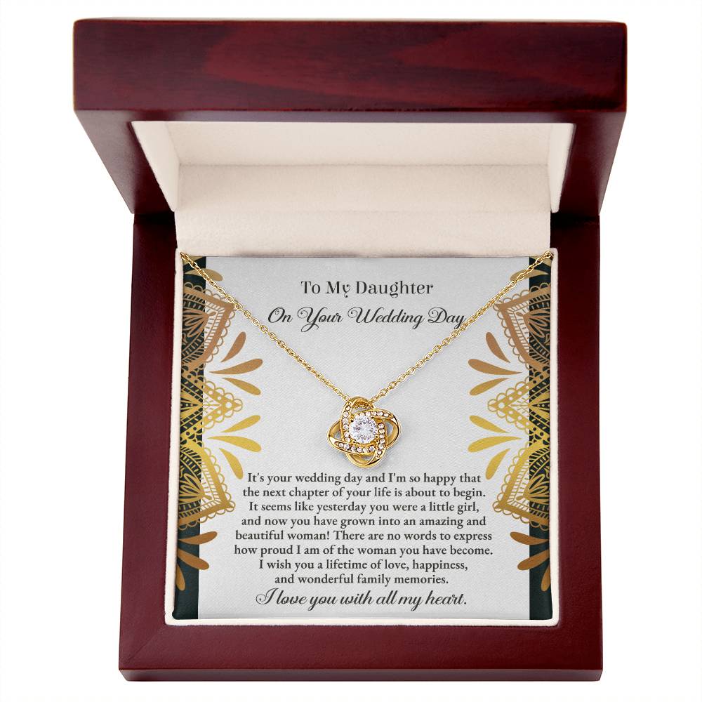 The "To Daughter, Wedding - A Little Girl - Love Knot Necklace" adorned with cubic zirconia crystals is elegantly showcased in a box containing a heartfelt message for a daughter on her wedding day. The text conveys love, pride, and best wishes for a joyful marriage, beautifully accentuated by the option of a white gold or yellow gold finish.