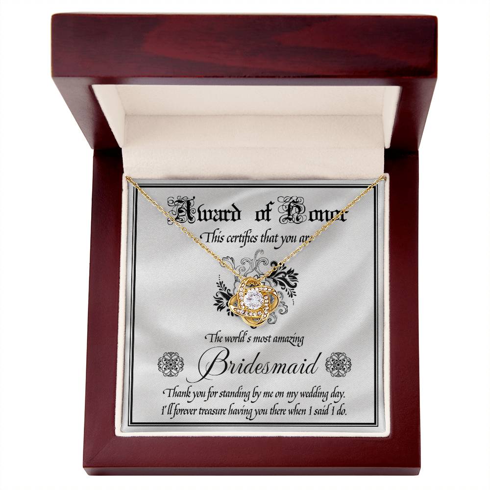 Introducing the "To Bridesmaid, Award Of Honor - Love Knot Necklace," a decorative certificate thanking the world's most amazing bridesmaid for her support on the wedding day. Featuring a Love Knot Necklace adorned with cubic zirconia crystals, this personalized gift is a heartfelt token of appreciation and love.