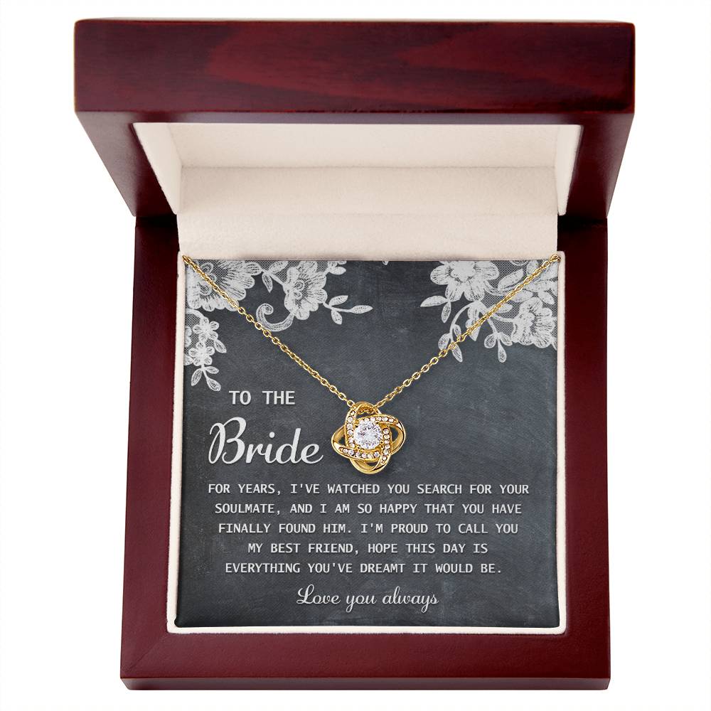 The "To Bride, My Best Friend - Love Knot Necklace" in silver, adorned with cubic zirconia crystals, is presented on a card with a sentimental message for the bride and comes in a decorated gift box.